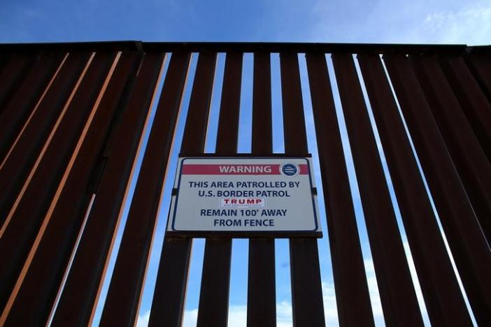 A Donald Trump for President campaign sticker is shown attached to a U.S. Customs sign hanging on the border fence between Mexico and the United States near Calexico, California, U.S. February 8, 2017. Picture taken February 8, 2017. REUTERS/Mike Blake
