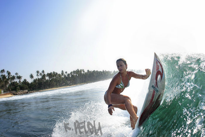 French-Hawaiian female surfer Elise Garrigue riding a left handed wave in Poljhena during a surf trip in Sri Lanka, february 2006.